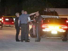 OPP officers gather near Lenore Street in Belle River to investigate the death of an 18-year-old Windsor male on the night of July 13, 2017.