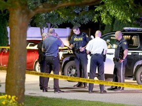 OPP officers gather near Lenore Street in Belle River to investigate the death of an 18-year-old Windsor male on the night of July 13, 2017.