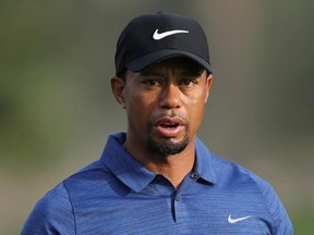 FILE - In this Feb. 2, 2017 file photo, Tiger Woods reacts on hole 10th during the 1st round of the Dubai Desert Classic golf tournament in Dubai, United Arab Emirates. Woods has checked out of the clinic where he went to get help dealing with pain medications, saying he will &ampquot;continue to tackle this going forward.&ampquot; The treatment follows the golfer&#039;s arrest on a DUI charge after he was found asleep at the wheel in Jupiter, Fla., around 2 a.m. on May 29, 2017. (AP Photo/Kamran Jebreili, File)