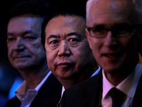 Interpol President, Meng Hongwei, center waits to deliver his opening address at the Interpol World congress on Tuesday, July 4, 2017, in Singapore. (AP Photo/Wong Maye-E)