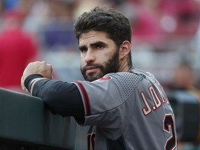 Arizona Diamondbacks right fielder J.D. Martinez stands in the dugout in the first inning of a baseball game against the Cincinnati Reds, Wednesday, July 19, 2017, in Cincinnati.