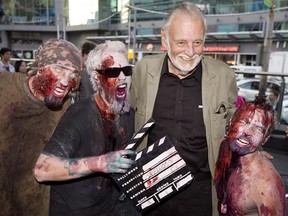 Director George Romero poses with some fans dressed as zombies after accepting a special award during the Toronto International Film Festival in Toronto on Saturday, September 12, 2009. George Romero, the horror director who brought new life to the living dead, will receive a fond farewell today in Toronto.THE CANADIAN PRESS/Darren Calabrese