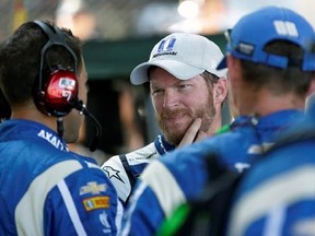 Dale Earnhardt Jr. (88) talks with his crew after dropping out of the NASCAR Brickyard 400 auto race at Indianapolis Motor Speedway in Indianapolis, Sunday, July 23, 2017. (AP Photo/AJ Mast)