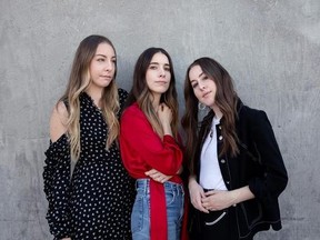 In this June 27, 2017 photo, Este Haim, from left, Danielle Haim and Alana Haim of Haim pose for a portrait in New York to promote their latest album, ‚ÄúSomething to Tell You.&ampquot; (Photo by Taylor Jewell/Invision/AP)