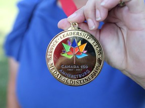 Nancy Loeffler-Caro displays her Canada 150 Medal of Distinction following a ceremony at Fort Malden in Amherstburg on July 1, 2017.