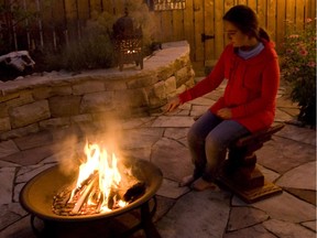 Rebecca Rogers roasts marshmallows at a portable firepit in the backyard of her home in 2009.