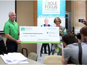 Jim Scott, president of Ground Effects, left, and  Canadian Mental Health Association, Windsor-Essex County Branch CEO Claudia den Boer Grima share a smile after Scott presented a cheque for $30,000 to the Sole Focus Project on Wednesday July  19, 2017.  The Sole Focus Project movement and takes a stand for mental health to collectively create a legacy fund to further enhance and distribute mental wellness education, awareness and training in our community.