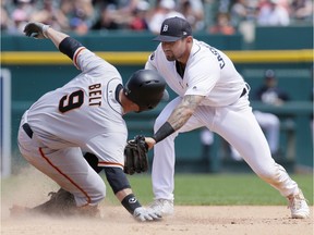 Brandon Belt of the San Francisco Giants slides into second beating the tag from third baseman Nicholas Castellanos of the Detroit Tigers during the sixth inning at Comerica Park on July 6, 2017 in Detroit, Michigan.