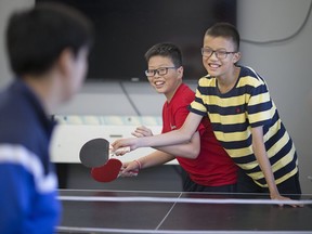 International students from China, Yuming Bao, 13, left, and Chenyuan Cao, 13, take a ping pong break during the International Summer Academy at Central Park Athletics, July 6, 2017.