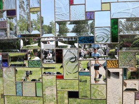 Visitors to the Art in the Park event at the Willistead Park in Windsor are seen through a stain glass windsor on Saturday, June 3, 2017.
