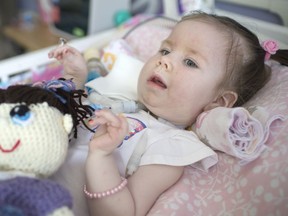 Eighteen-month-old, Lilah Lamont, who suffers from spinal muscular atrophy, lies in her bed at home Thursday, July 6, 2017.  Lilah has been taking a newly approved drug, Spinraza, which has dramatically improved her condition.