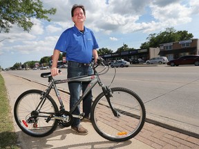 Windsor city Coun. Paul Borrelli stands with his bike in the 3000 block of Dougall Avenue on July 4, 2017.