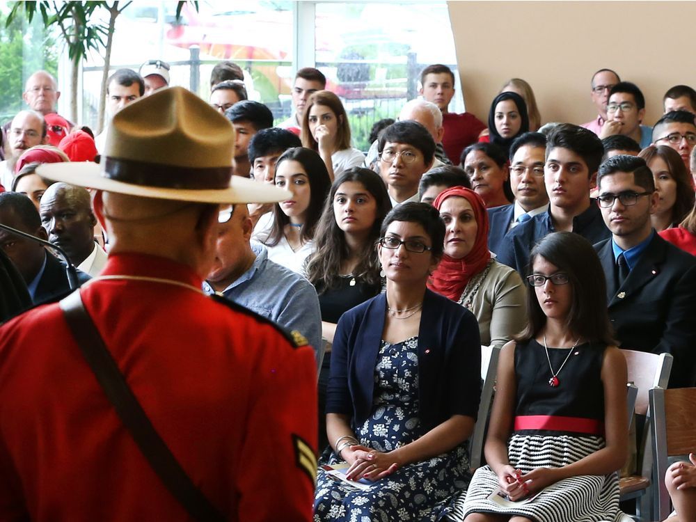 People take part in a Canada Day citizenship ceremony before the