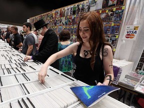 Andrea Belmore, an attendee of the 2015 edition of Windsor ComiCon, browses the bins for comic books.
