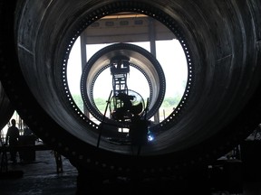 A CS Wind employee at the Windsor plant works inside a wind turbine tower in June 2015.