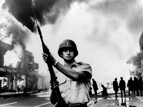 In this July 1967 file photo, a National Guardsman stands at a Detroit intersection during riots in the city. Detroit wasn't the first of the riots in the summer of 1967. More than 150 cases of civil unrest erupted across the United States.