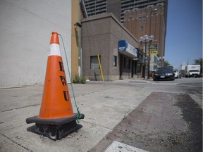 An orange cone sits on top of a light post outlet on University Avenue East in downtown Windsor July 27, 2017.