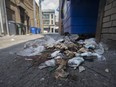 A heap of garbage full of Starbucks containers lies in the alley between Ouellette Avenue and Pelissier Street off University Avenue in downtown Windsor on July 27, 2017.