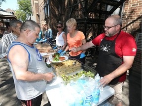 Volunteers serve food at the Downtown Mission in Windsor on July 31, 2017.