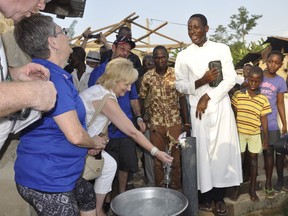 Windsor's Kim Spirou, centre, samples water from a well in Ghana, Nov. 16, 2016. The Rotary of Club of Essex is recruiting volunteers for its next humanitarian mission to Ghana to help dig wells, rebuild a school and hand out mosquito nets in November.