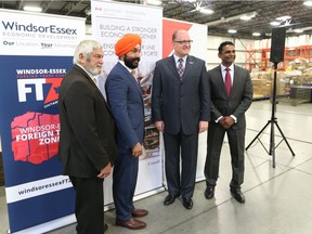 Warden Tom Bain, Hon. Navdeep Bains, Mayor Drew Dilkens, and WEEDC's Rakesh Naidu (left to right) take part in a press conference at Farrow Logistics  in Windsor on July 31, 2017.