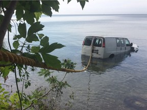 A van sits in Lake Erie on July 21, 2017 after it was driven off a cliff at the end of Baldwin Road south of County Road 50 in Essex.