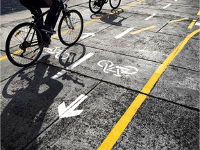 Cyclists follow a cycle track on the street.