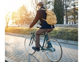 A man cycles along a road.