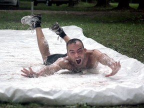 Dan Allaire, WRACE (Walkers and Runners Around the County of Essex) vice president, goes down the slip and slide at the Wet and Wildlife Hawk Run at Holiday Beach Sunday, Aug. 24, 2014.