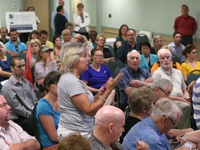 Residents ask questions during a public consultation meeting in Windsor Wednesday night on proposed zoning changes to an area south of Windsor Airport that includes the designated location for a new mega-hospital.