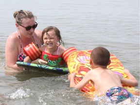 Taylor Bennett and her children Dreyden, 6, and Kinsleigh, 3, escape the heat at Seacliff Beach in Leamington on July 21, 2017. Environment Canada's heat warning continues into the weekend.