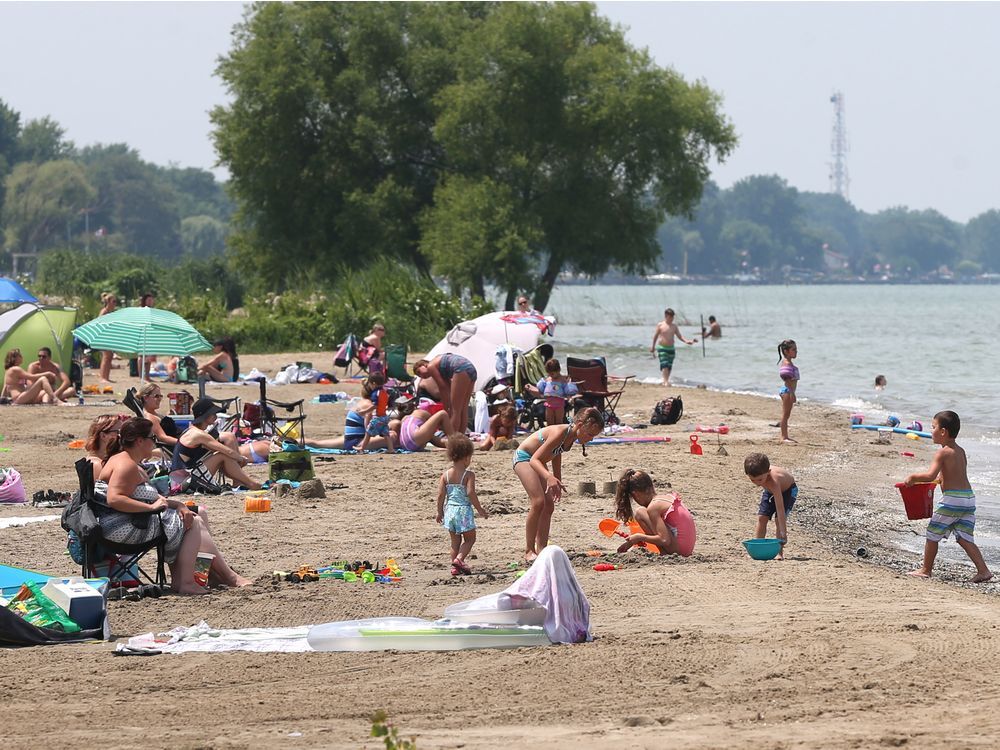 Beachgoers enjoy the waters of Lake St. Clair while spending an afternoon at West Lakeside Beach in Belle River, Ontario on July 21, 2017.  