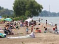 Beachgoers enjoy the waters of Lake St. Clair while spending an afternoon at West Lakeside Beach in Belle River, Ontario on July 21, 2017.