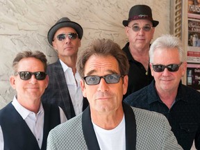 1980s pop-rock icons Huey Lewis and the News pose for a promotional image.