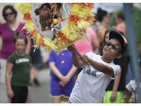 A smashingly good time was had by the children lining up to hit a piñata full of sweets at Fiesta Latina 2017 at Maiden Lane, July 22, 2017.