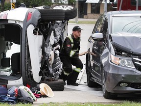 The southbound lanes of Lauzon Road were closed for more than an hour on July 3, 2017, as a result of a two-car collision at Tecumseh Road East. A tow truck operator is shown at the scene of the crash.