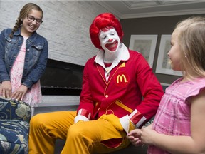 Ronald McDonald chats with sisters Gabby Pizzuti, left, and Daniella Pizzuti, during the unveiling of the Ronald McDonald House Windsor, May 6, 2016.