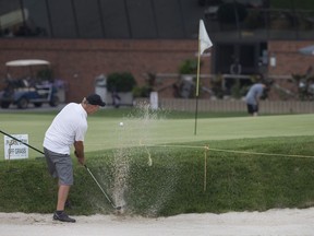 Scott Merryfield hits out of a bunker on the 18th hole at Roseland Golf and Curling Club, Wednesday, July 19, 2017.