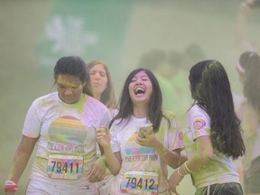 Participants soak up coloured dye during the Color Run along Windsor's riverfront, Saturday, July 22 2017.