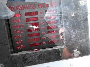 Sam Fallon, owner of Sam's Pampered Pets in Belle River, looks at shattered plexiglass at his place of business on July 24, 2017.