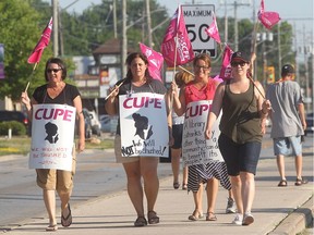 Striking CUPE library workers picket in front of the Tecumseh municipal building in July 12, 2016.