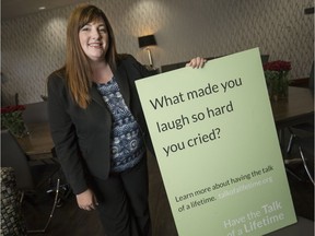 Jennifer Wells, of Families First funeral homes, holds a Talk of a Lifetime card, intended as a conversation starter for families dealing with the end-of-life process, July 29, 2017.