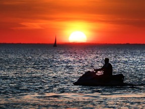 The sun sets over Lake St. Clair under extreme hot temperatures on June 12, 2017 as seen from Lakeshore, Ont.
