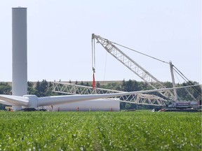 Construction crews build a series of wind turbines on land between Lakeshore Road 111 and Lakeshore 113 in Lakeshore on Wednesday.