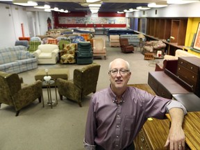 Bob Cameron , Director of the Downtown Windsor Community Collaborative sorts through furniture at the  We Love Windsor Furniture Bank on Marion Avenue in Windsor, Ontario on July 24, 2017.   The building has been sold.