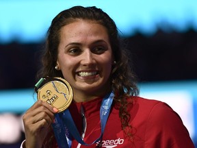 Kylie Masse celebrates on the podium after the women's 100m backstroke final during the swimming competition at the 2017 FINA World Championships in Budapest, July 25, 2017.