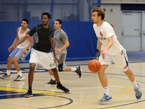 The University of Windsor Lancers Anthony Zrvnar, right, a former St. Anne Saints player, carries the ball during practice at St. Denis Centre Wednesday August 9, 2017.