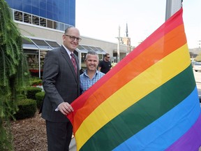 Mayor Drew Dilkens, left, and David Lenz, president of the Windsor-Essex Pride Fest, prepare to raise the Pride flag during Windsor-Essex Pride Fest flag raising ceremony at City Hall Wednesday August 9, 2017.