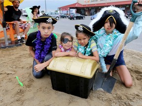 Arrgh! There be treasure here. Pirate siblings, from left, Austyn Whiteye, 10, Kaliyah Sword, 3, Kason Sword, 6, and Keira Sword, 9, at Urban Beach Experience at The City Market, 1030 Walker Rd., August 11, 2017.  Ford City Retro Camp Festival takes place here Sept. 1 to 2.