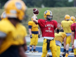 Quarterback Sam Girard, centre, works during team drills on Friday as training camp opened for the University of Windsor Lancers football team. Girard has earned the No. 1 job. NICK BRANCACCIO/Windsor Star)